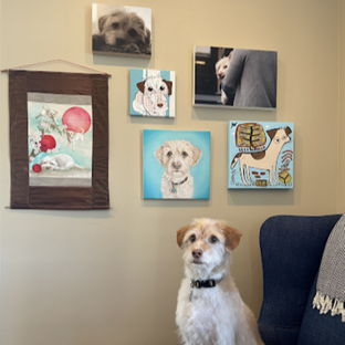  Rolo the dog in front of her gallery wall of portraits, including a painting by UGallery artist Jessica JH Roller 